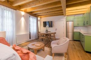 a living room with a couch and a table at Apartamentos La Botica in Comillas