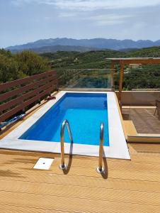 a swimming pool on a deck with a view at Wish Sea & Mountain View in Stalos