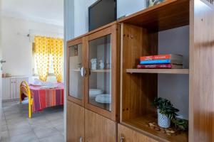 a wooden cabinet with a tv in a room at Villa Rosa Sea View in Valledoria +84 photos