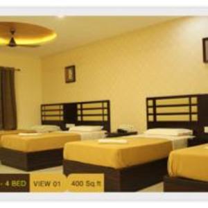 Postel nebo postele na pokoji v ubytování Hotel M.P Temples Inn