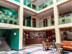 a lobby of a building with a table and chairs at SPA Amber Palace in Šventoji