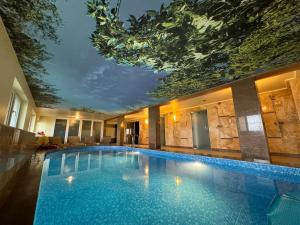 a large swimming pool in a hotel with a ceiling at SPA Amber Palace in Šventoji