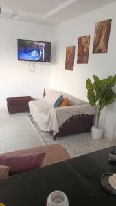 a bedroom with a bed and a tv on the wall at appart kelibia a 10 minutes d une belle plage el fatha in Kelibia