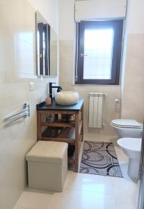 a bathroom with a sink and a toilet at Cristine's House in Marino +27 photos
