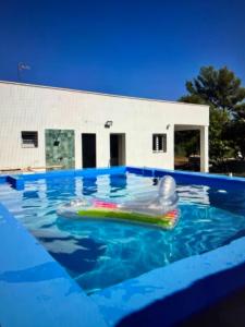 a pool with an inflatable raft in the water at Tossal del Pla in Estivella