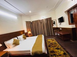 a hotel room with a bed and a window at Teyser Holiday Home in Leh