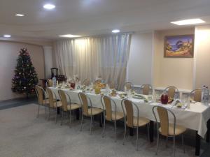 a room filled with tables and chairs filled with christmas decorations at Volna Hotel in Samara