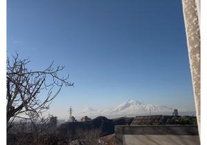 a view of a snow covered mountain in the distance at Nana Grand Hotel Yerevan in Yerevan