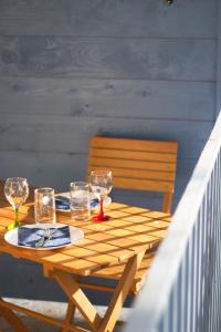 una mesa de madera con copas de vino y un plato en ella en Simple Pleasures Shekvetili, en Shekhvetili