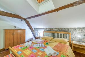 a bedroom with a bed with towels on it at Tourist Farm Pri Živcovih in Dutovlje