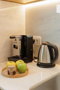 a kitchen counter with a coffee maker and apples at Aritis 3 in Corfu