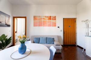 a living room with a table and a couch at Relax in Riva by MONHOLIDAY in Monopoli