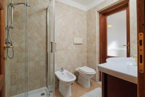 a bathroom with a toilet and a sink and a shower at Bella Vista su tavolara 4 in Porto San Paolo +13 photos
