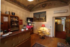 a bar in a room with a table and chairs at Hotel PRime in Pistoia