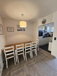 a dining room and kitchen with a table and chairs at Ferienhaus 1260 in Tossens in Tossenserdeich