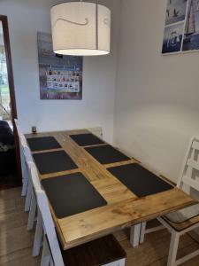 a dining room table with chairs and a light fixture at Ferienhaus 1260 in Tossens in Tossenserdeich