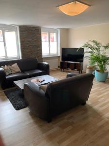 a living room with a couch and a table at Modernes wohnen im alten Beelitz Wohnung 1 in Beelitz