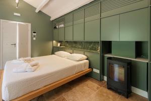 a bedroom with a bed and a flat screen tv at Aritis 3 in Corfu