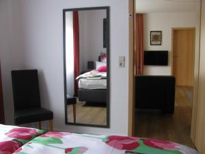 a mirror in a room with a bed and a bedroom at Ferienwohnung RoSi in Ebermannstadt
