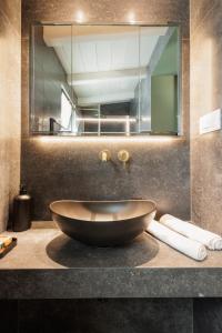 a bathroom with a large bowl sink on a counter at Aritis 3 in Corfu