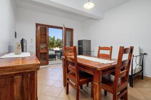 a dining room with a wooden table and chairs at Bella Vista su tavolara 5 in Porto San Paolo