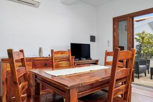 a dining room with a wooden table and chairs at Bella Vista su tavolara 5 in Porto San Paolo