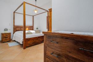 a bedroom with a bed with a wooden frame at Bella Vista su tavolara 5 in Porto San Paolo