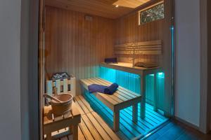 a room with a sauna with a bench and a sink at Villa Costanza- private heated pool, steam room & sauna - Bellagio Village Residence in Oliveto Lario +19 photos