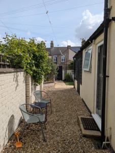 a patio with two chairs and a table at Spacious 3 bed house near beach! in Lowestoft