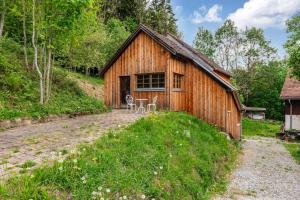 a barn with a table and chairs in front of it at Hofgut Heiligenberg in Heiligenberg