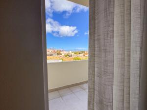 a room with a window with a view at Refúgio dos Arrifes in Vila Baleira