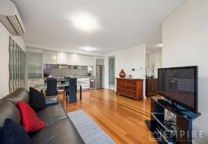 a living room with a couch and a television at Parklane Apartments in Fremantle