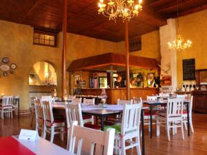 a dining room with tables and chairs in a restaurant at Die Blou Nartjie in Calvinia