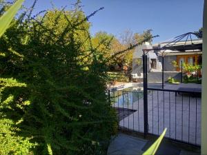 a fence in front of a house with a swimming pool at Die Blou Nartjie in Calvinia