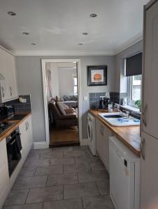 a kitchen with a sink and a counter at Spacious 3 bed house near beach! in Lowestoft