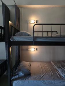 two bunk beds in a room with lights on them at Buddy Hostel in Chiang Rai