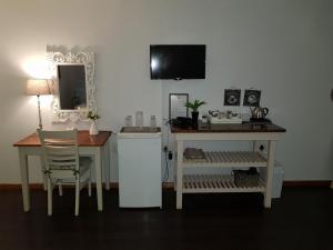 a room with a desk and a table and a mirror at Die Blou Nartjie in Calvinia