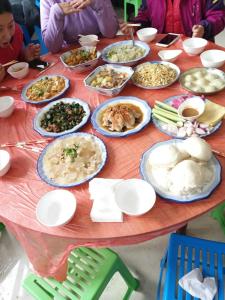 a table with many plates of food on it at Wusong Island Wusong Country House in Jilin