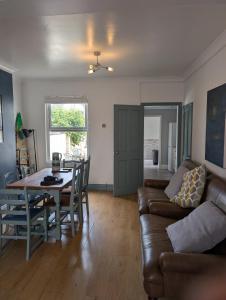 a living room with a couch and a table at Spacious 3 bed house near beach! in Lowestoft