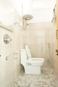 a bathroom with a toilet and a shower and a sink at hotel the kannaz in Srinagar +19 photos