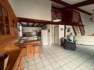 a kitchen with a refrigerator and a table in a room at L'Ancre Marine in Valras-Plage