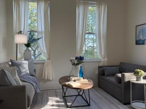 a living room with a couch and a table at Fox Point Landing Residences in Providence