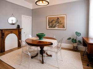 a dining room with a table and chairs at Charm on Forster in Invermay