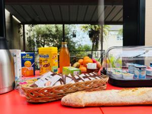 a table with a basket of food on a table at Hébergement Centre Missionnaire Saint Jacques in Guiclan +22 photos