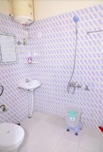a bathroom with a toilet and a sink and a shower at The Boho Stays in Shimla