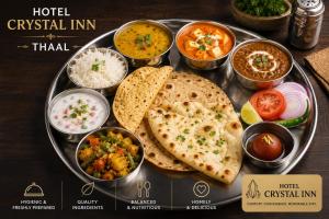 a plate of food with different types of food at Hotel Crystal Inn in Lucknow