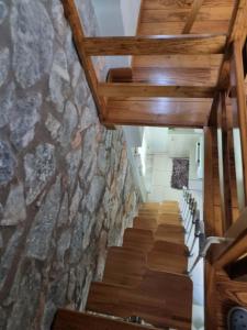 a staircase in a building with a stone wall at Οικοδέσπινα in Mytilene