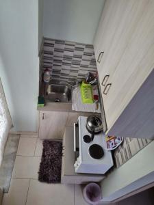 a small kitchen with a sink and a stove at Οικοδέσπινα in Mytilene