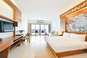 a hotel room with a bed and a flat screen tv at SYLVAN Koh Chang in Ko Chang