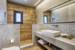 a bathroom with a sink and a mirror at Luxury Villa with Private Pool in Skopelos, Nature Retreat, Villa Pine Trees by Kardous in Alikias +35 photos
